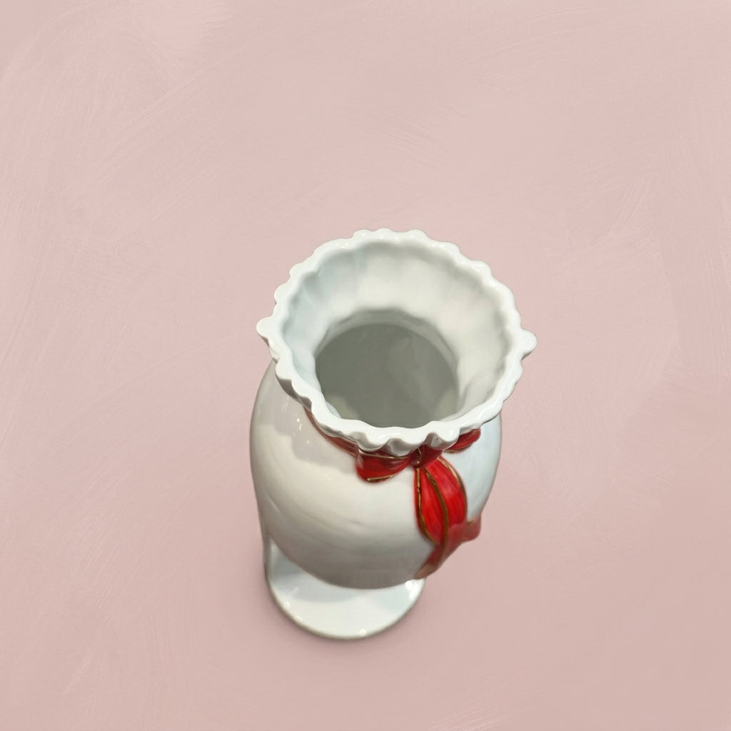 〈精彩連連〉彩頭瓶白瓷藝術品俯視特寫，展現花瓣狀瓶口與頸部紅色金邊蝴蝶結細節
